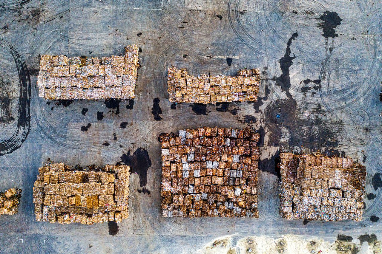 Aerial view of organised recyclable material stacks at a processing yard